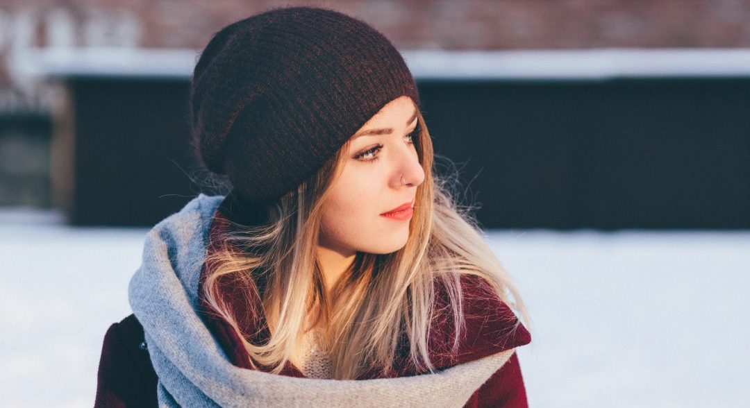 woman on snowy day in black stocking hat