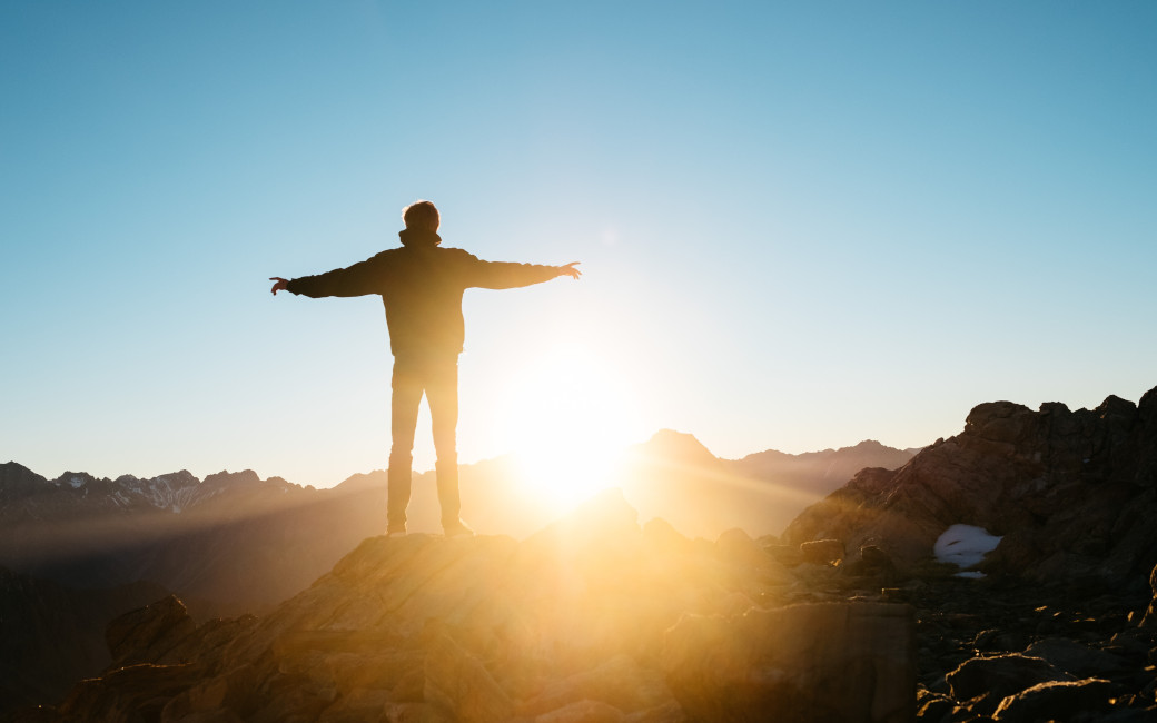 image of man looking into sunrise